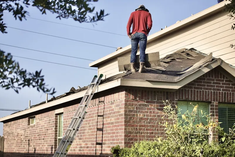 Professional roofer working on a residential roof in Hendrickson Corners
